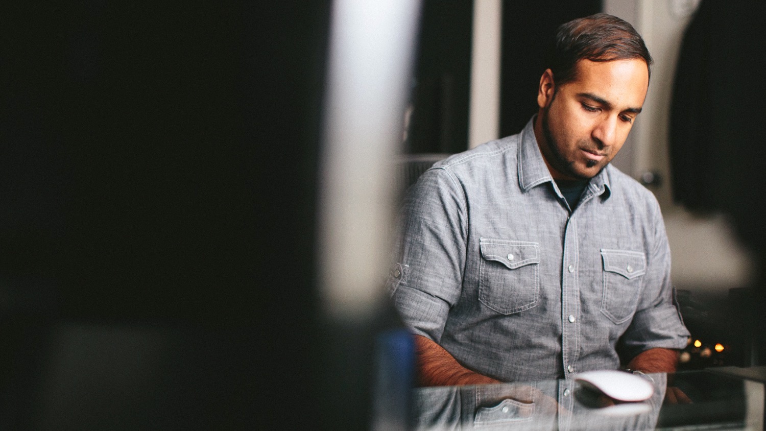 Roy Oommen working at his desk in the studio
